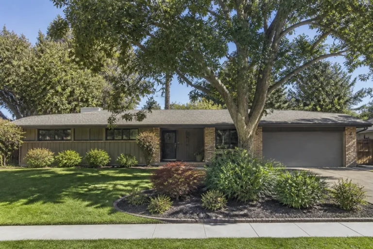 Sunnyvale mid-century home with a broad low-slope roof and mature shade trees